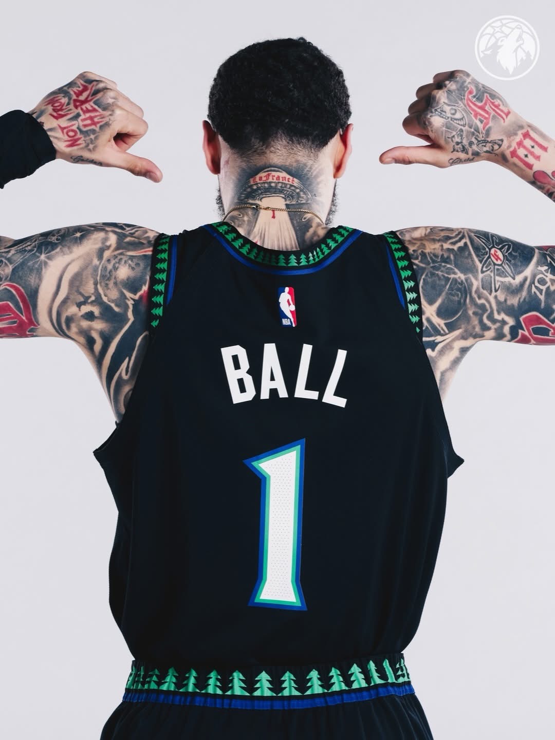 LaMelo Ball pointing to BALL #1 on his black Wolves jersey