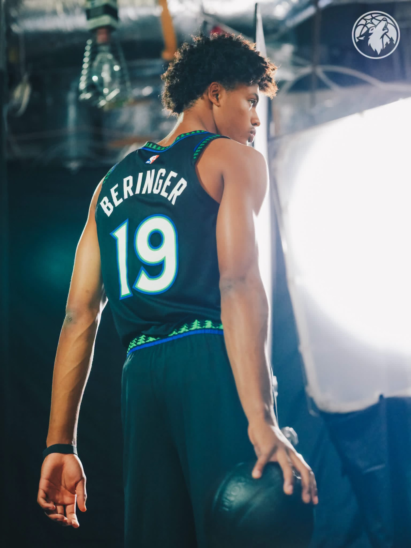 Beringer looking over his shoulder in the black Wolves #19 city edition jersey, ball in hand
