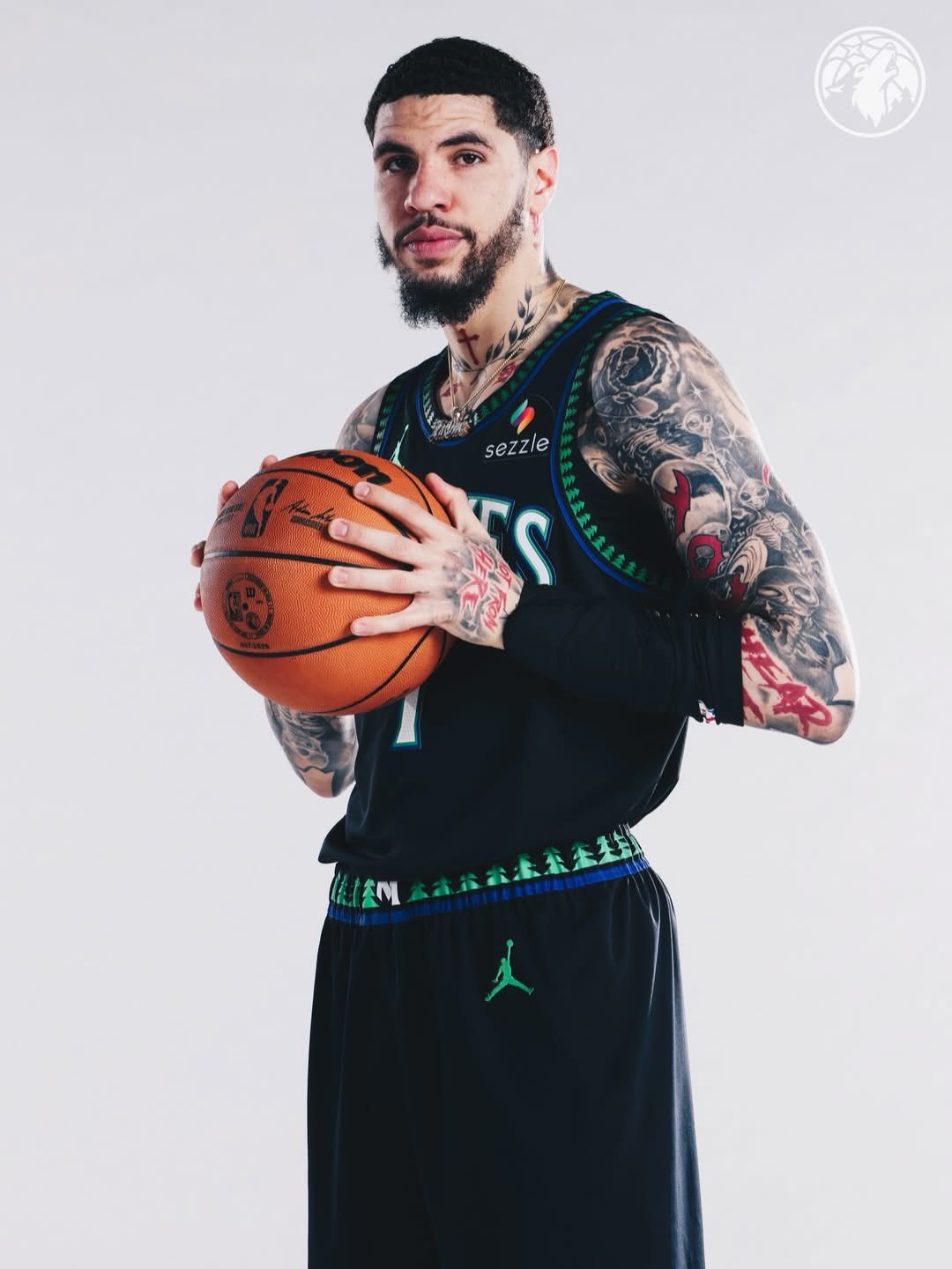 LaMelo Ball holding a basketball in the black Wolves city edition jersey