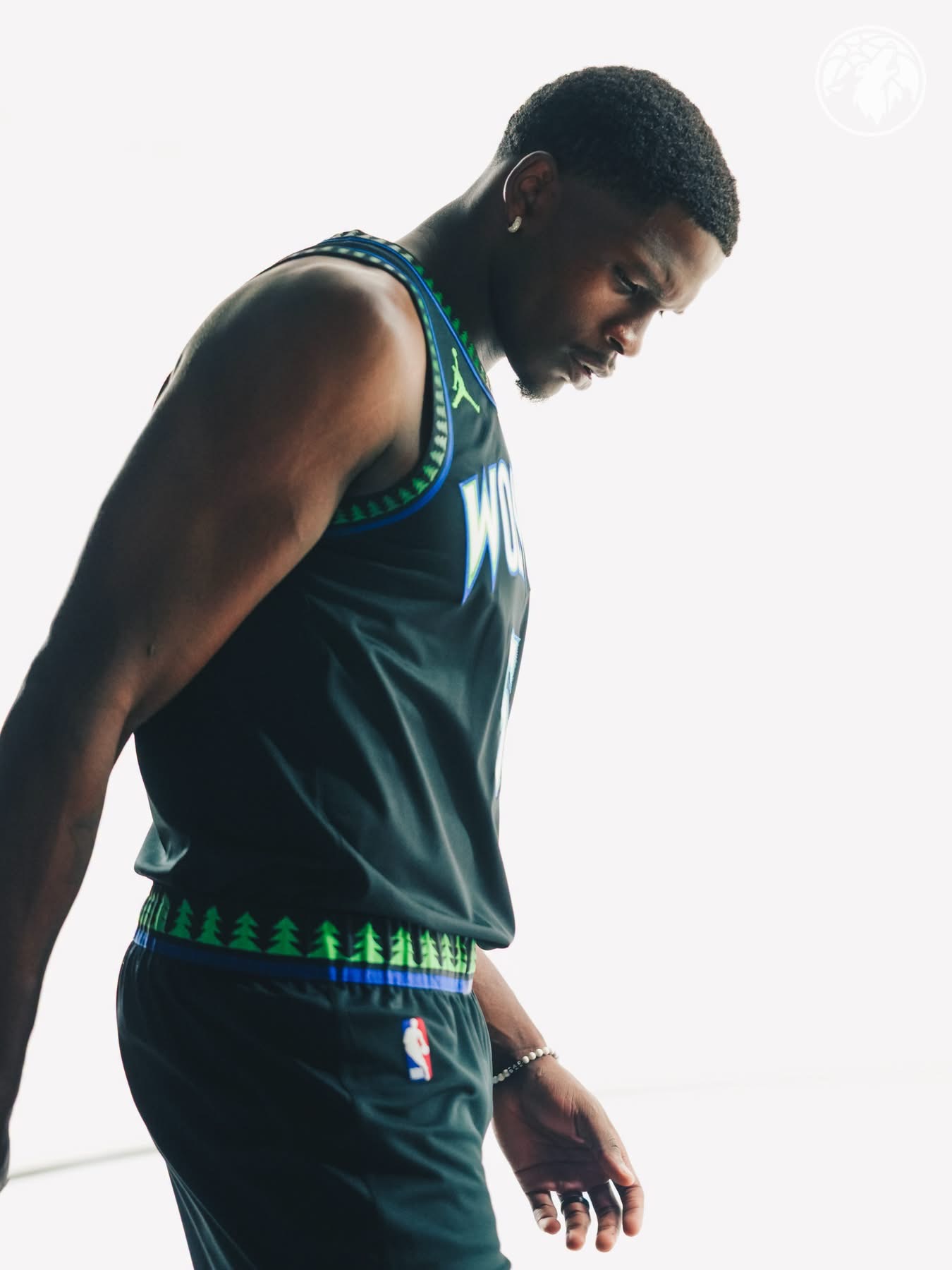 Anthony Edwards looking down in the black Wolves city edition jersey with pine tree trim
