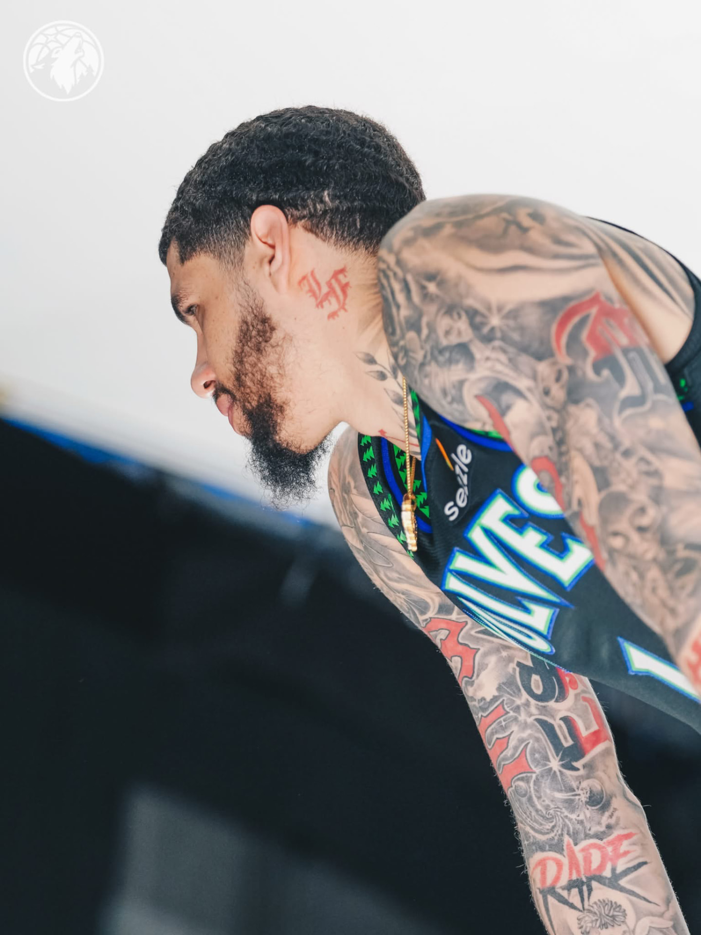 LaMelo Ball in profile showing his tattoos and black Wolves jersey